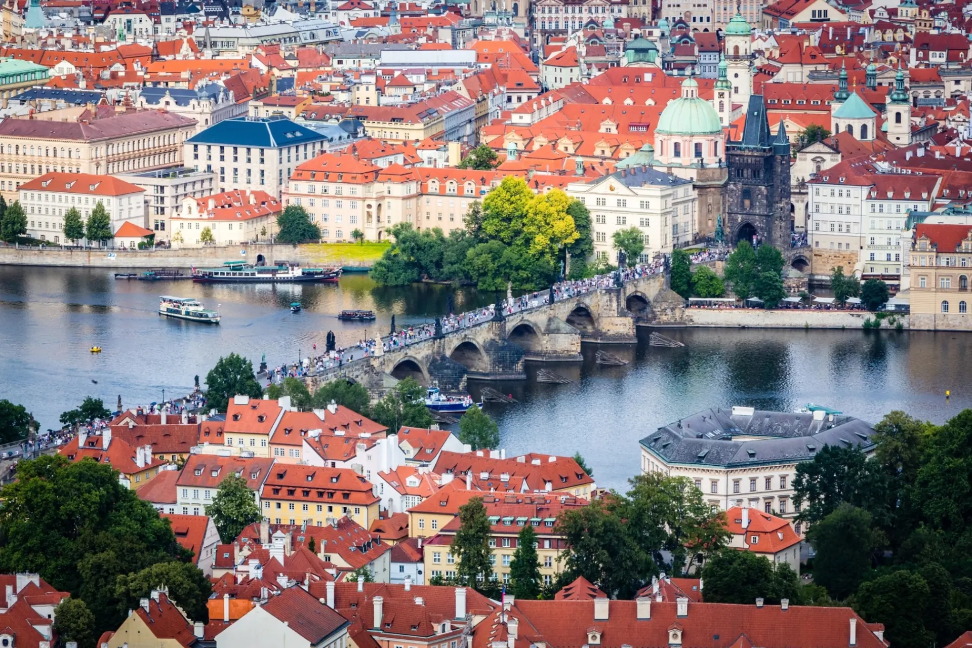 Historic Prague rooftops and the Charles Bridge over the Vltava River, home to VDB Groupe's European investment office.